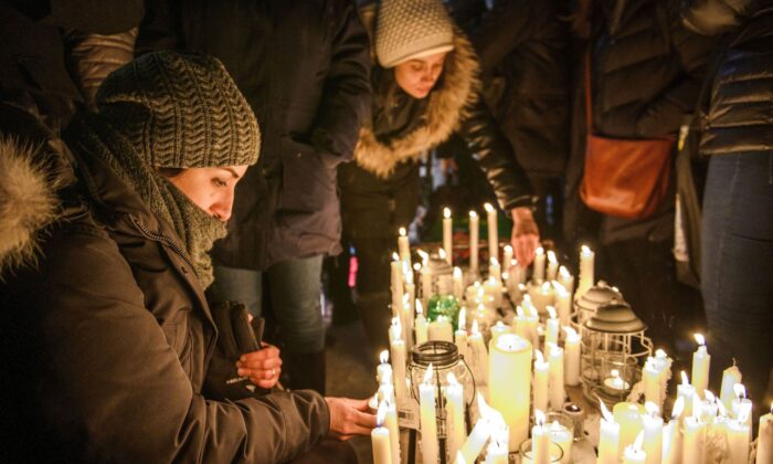 Members of Montreal's Iranian community attend a vigil in downtown Montreal on Jan. 9, 2020, to mourn victims of the Iranian air crash. Foreign Minister Francois-Philippe Champagne says he sees progress in persuading Iran to relinquish the black boxes from the Ukrainian jetliner that crashed near Tehran on Jan. 8. (The Canadian Press/Andrej Ivanov)