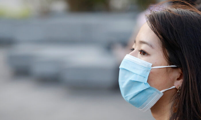 A woman wearing a face mask is seen in Ho Chi Minh, Vietnam, on Feb. 13, 2020. (Yen Duong/Reuters)