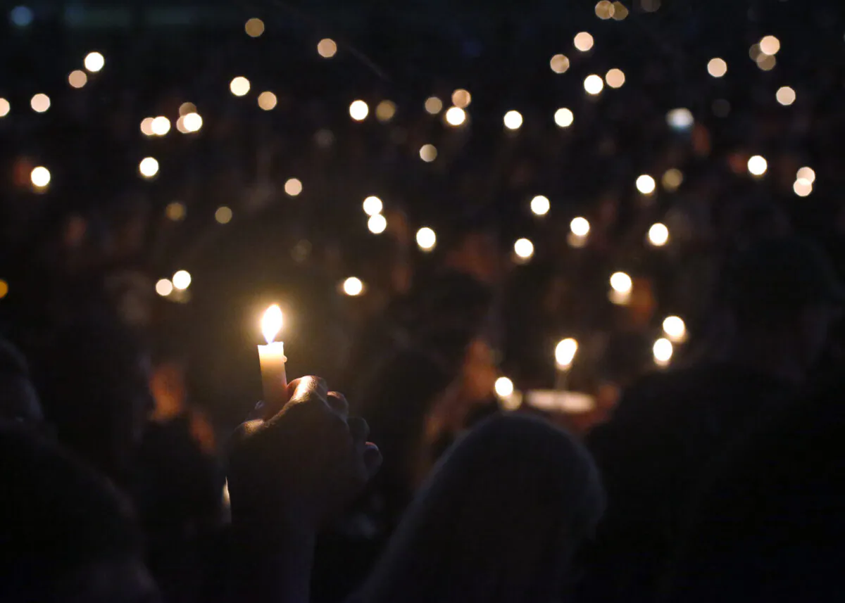 Attendees hold up their candles at a candlelight vigil for the victims of the shooting at Marjory Stoneman Douglas High School, in Parkland, Fla., on Feb. 15, 2018. (Wilfredo Lee/AP Photo/File)