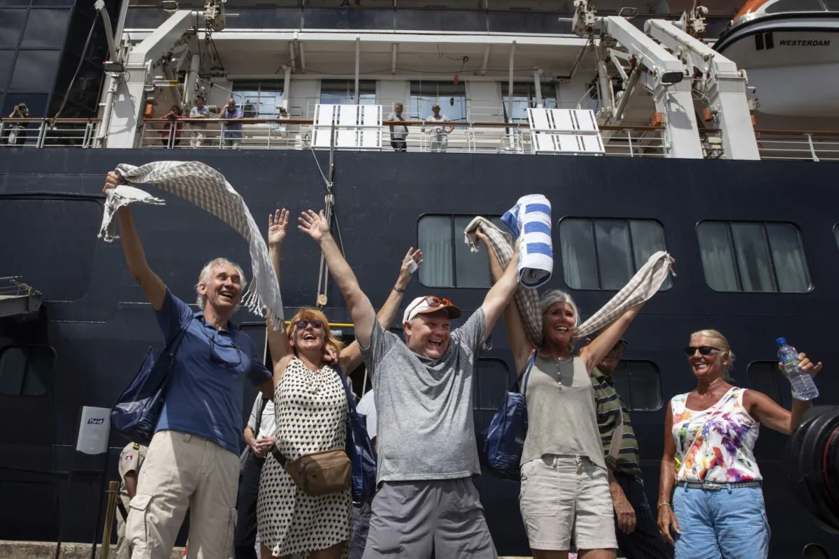 Excited passengers disembark from the MS Westerdam cruise ship after being stranded for two weeks, now docked in Sihanoukville, Cambodia on Feb. 14, 2020. (Paula Bronstein/Getty Images)