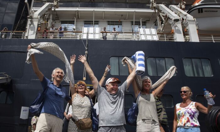 Excited passengers disembark from the MS Westerdam cruise ship after being stranded for two weeks, now docked in Sihanoukville, Cambodia on Feb. 14, 2020. (Paula Bronstein/Getty Images)