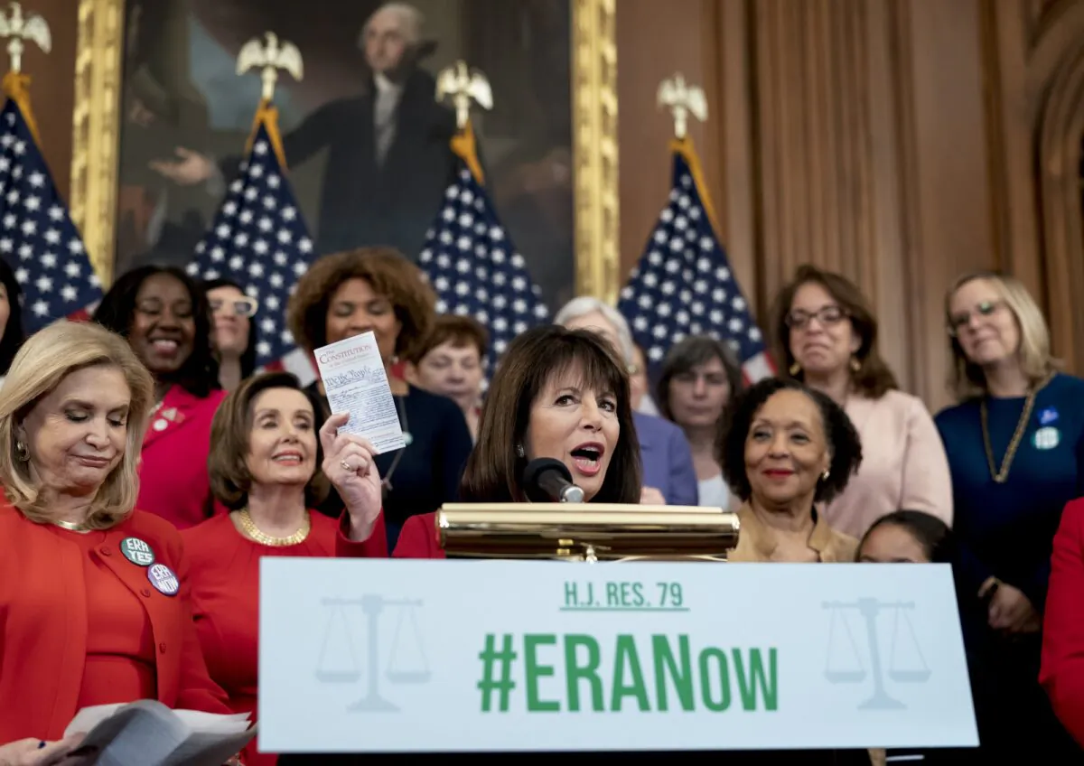 Rep. Jackie Speier, D-Calif., joined from left by Rep. Carolyn Maloney, D-N.Y., and Speaker of the House Nancy Pelosi, D-Calif., and other congressional Democrats, holds up a copy of the Constitution during an event about their resolution to remove the deadline for ratification of the Equal Rights Amendment at the Capitol in Washington on Feb. 12, 2020. (J. Scott Applewhite/AP Photo)