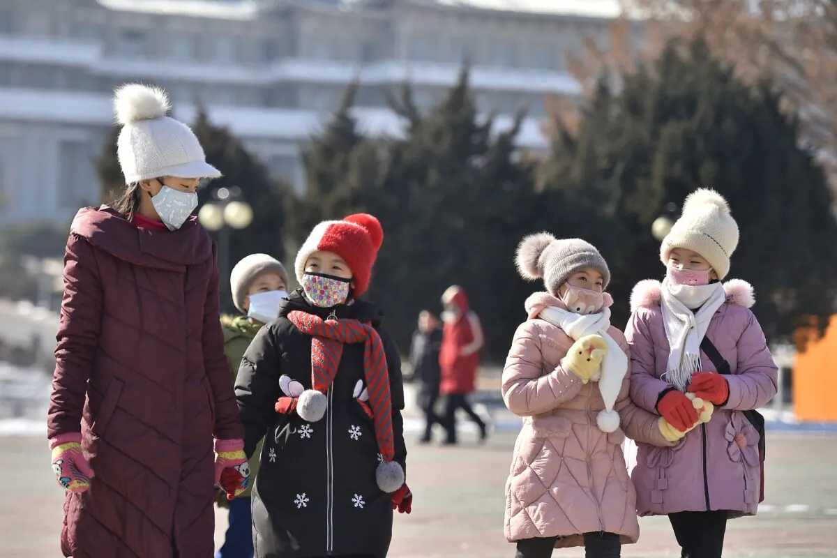 In this photo taken on Feb. 6, 2020, people wearing face masks walk in Pyongyang, North Korea. (Kim Won-Jin/AFP via Getty Images)