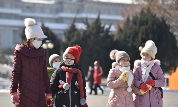 In this photo taken on Feb. 6, 2020, people wearing face masks walk in Pyongyang, North Korea. (Kim Won-Jin/AFP via Getty Images)