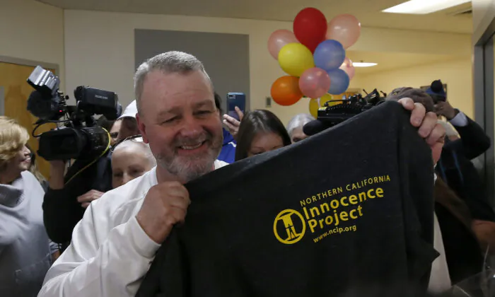 Ricky Davis holds up a shirt with the logo of the Innocence Project after he was released from custody at the El Dorado County Jail in Placerville, Calif. on Feb. 13, 2020. (Rich Pedroncelli/AP)