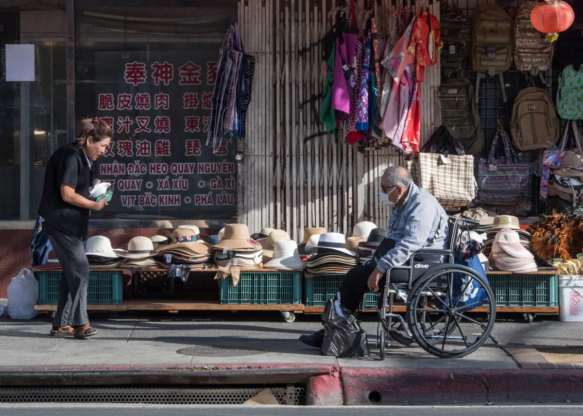 Shoppers are seen by a deserted Los Angeles Chinatown as most stay away due to fear of the novel coronavirus, COVID-19, epidemic after the US has now 15 confirmed cases, in Los Angeles, California, on Feb. 13, 2020. (Mark Ralston/AFP via Getty Images)
