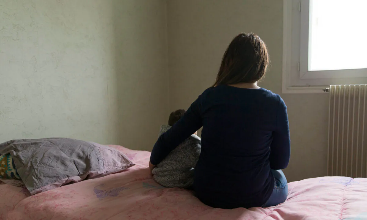 A mother and her child pose in a room in a temporary apartment of the Home Association in Paris on Nov. 22, 2016.  Geoffroy Van der Hasselt/AFP via Getty Images