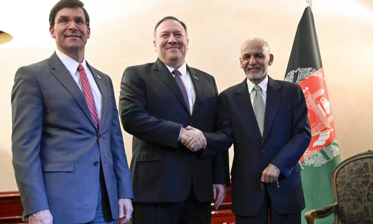Secretary of State Mike Pompeo (C), shakes hands with Afghan President Ashraf Ghani (R), as Secretary of Defense Mark Esper watches during the 56th Munich Security Conference (MSC) in Munich, Germany, on Feb. 14, 2020. (Andrew Caballero-Reynolds/Pool photo via AP)