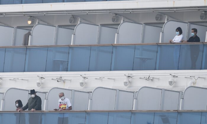 Passengers on balconies on the Diamond Princess cruise ship, at the Daikoku Pier Cruise Terminal in Yokohama port, Japan, on Feb. 14, 2020. (Charly Triballeau/AFP via Getty Images)