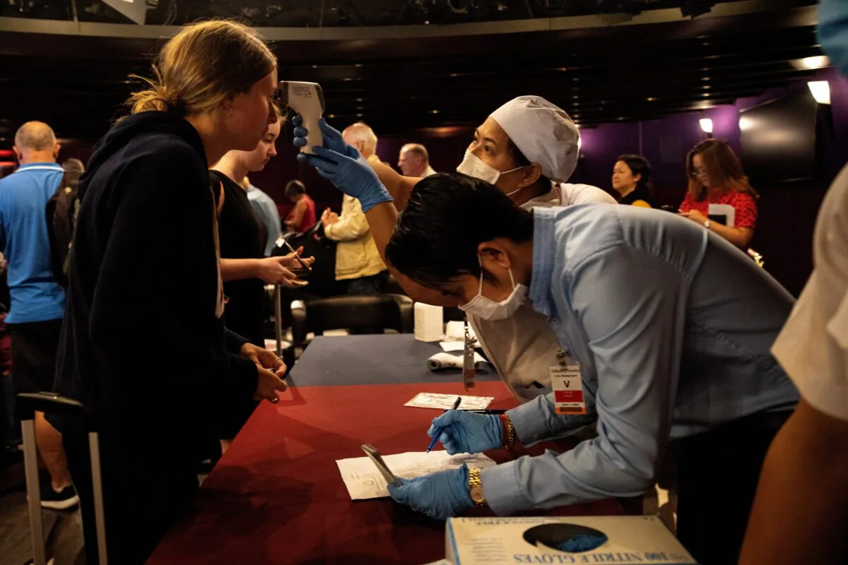 Passengers waiting to travel home get a last health screening before disembarking from the MS Westerdam cruise ship in Sihanoukville, Cambodia on Feb. 15, 2020. (Paula Bronstein/Getty Images)