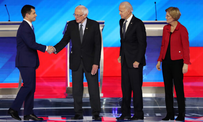 Democratic presidential candidates former South Bend, Indiana, Mayor Pete Buttigieg and Sen. Bernie Sanders (I-VT) shake hands as former Vice President Joe Biden and Sen. Elizabeth Warren (D-MA) look on prior to the start of the Democratic presidential primary debate in the Sullivan Arena at St. Anselm College on Feb. 07, 2020 in Manchester, New Hampshire. (Joe Raedle/Getty Images)