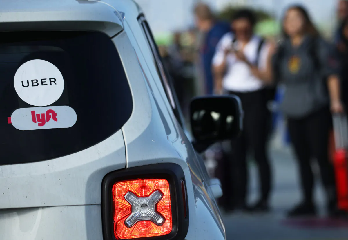 Arriving passengers wait to board Uber vehicles at Los Angeles International Airport (LAX) in Los Angeles on Nov. 6, 2019. (Mario Tama/Getty Images)