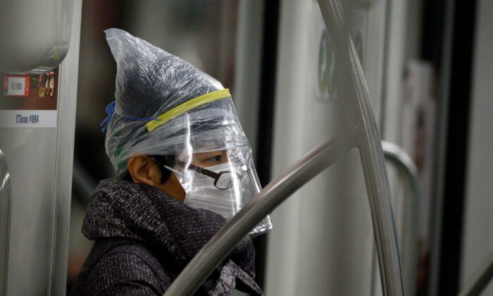 A subway passenger wears a facemask among other protective items in Shanghai on Feb. 12, 2020. (NOEL CELIS/AFP via Getty Images)