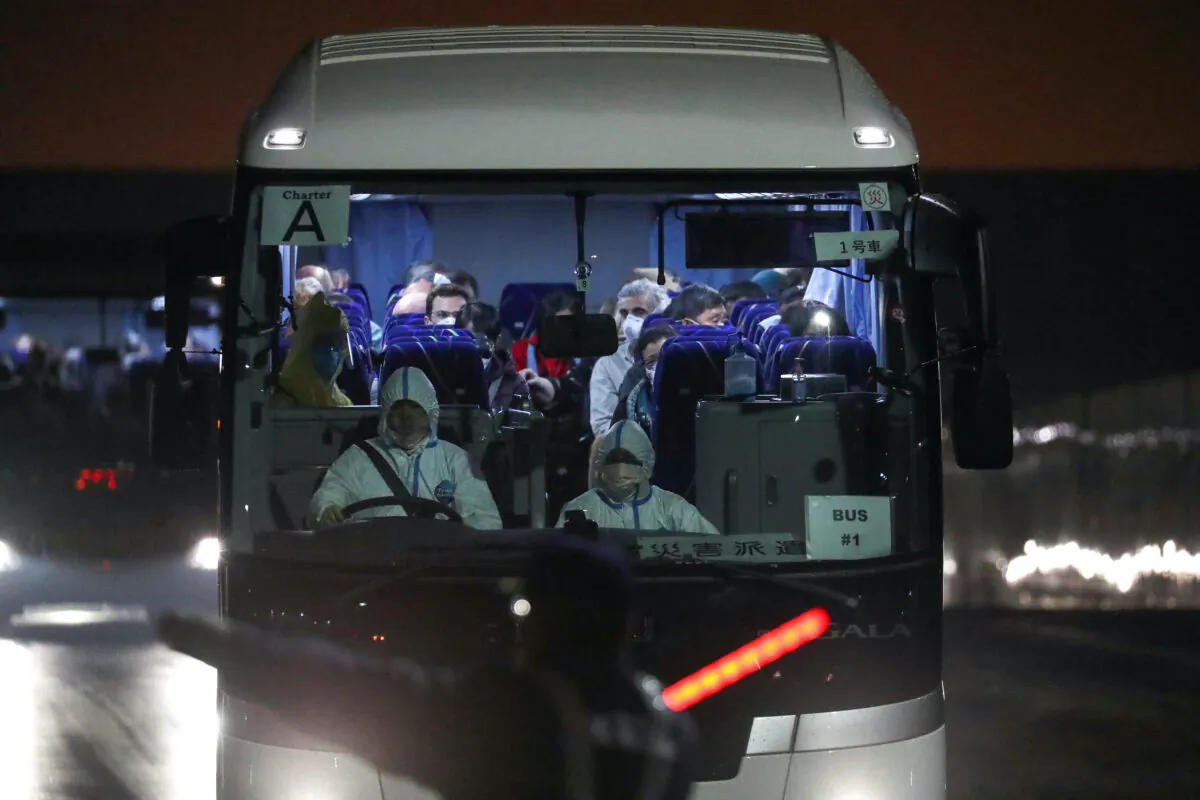 Buses believed to carry the U.S. passengers of the cruise ship Diamond Princess leave the Daikoku Pier Cruise Terminal in Yokohama, south of Tokyo, Japan on Feb. 17, 2020. (Athit Perawongmetha/Reuters)