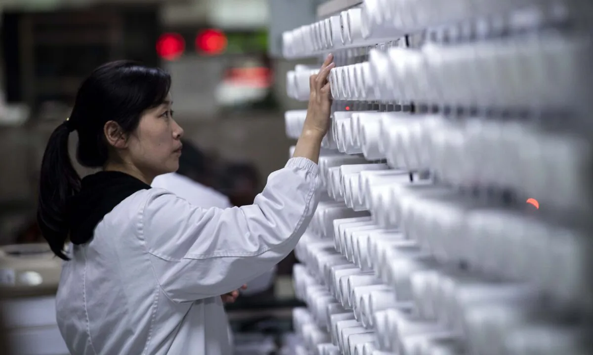 A woman sorts medicine in the pharmacy of the Yueyang Hospital, part of the Shanghai University of Traditional Chinese Medicine, in Shanghai, Nov. 7, 2018. Johannes Eisele/AFP via Getty Images