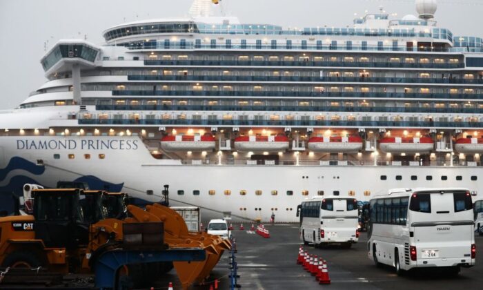 Two buses arrive next to the Diamond Princess cruise ship, with people quarantined onboard due to fears of the new coronavirus, at the Daikaku Pier Cruise Terminal in Yokohama port in Japan, on Feb. 16, 2020. (Behrouz Mehri/AFP via Getty Images)