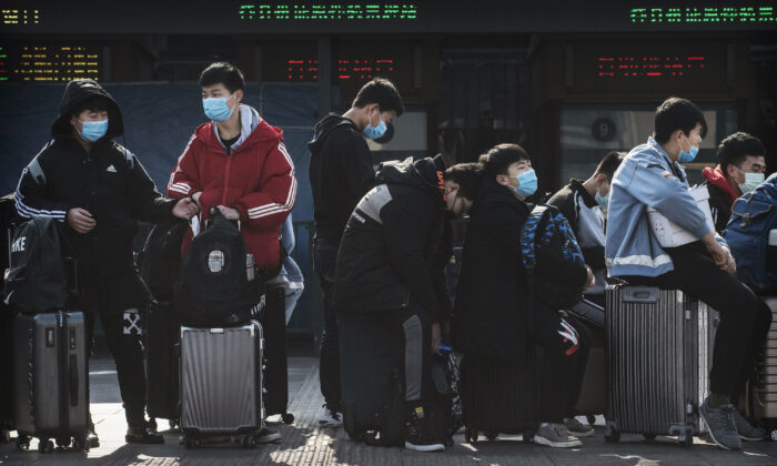 Chinese students wear masks as they wait to take a train after Chinese New Year break in Beijing, China, on Jan. 31, 2020. (Kevin Frayer/Getty Images)