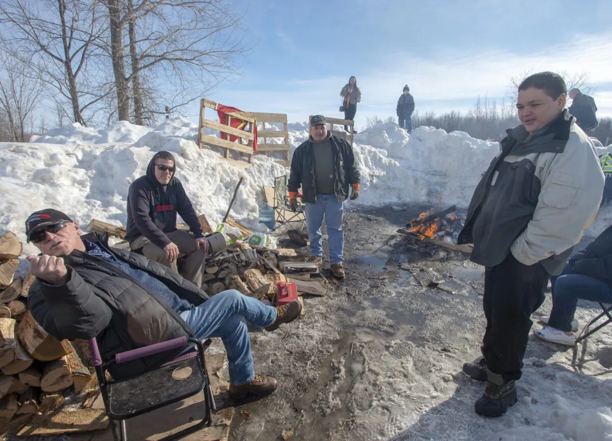 Members of the Mohawk community man a blockade of the commuter rail line in Kahnawake, Quebec, on Feb. 12, 2020. (The Canadian Press/Ryan Remiorz)