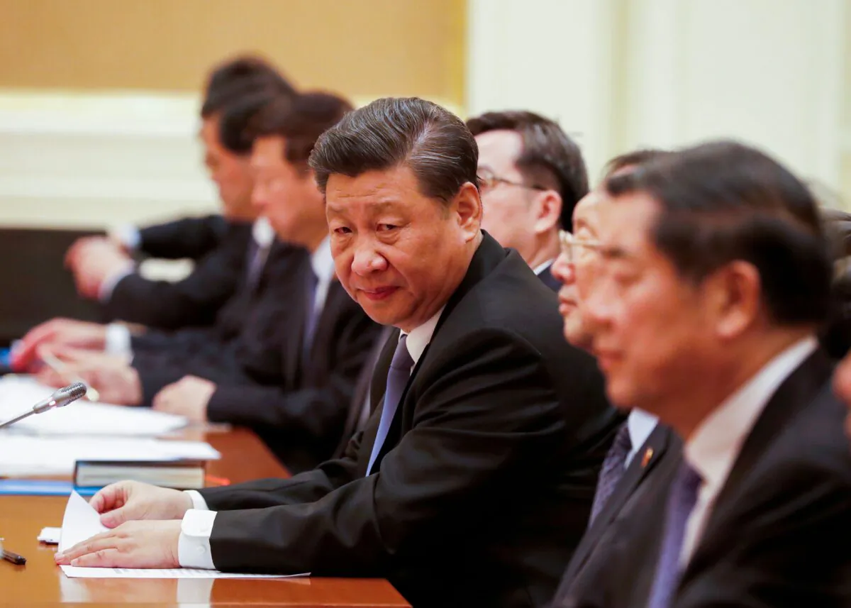Chinese President Xi Jinping (C) attends a bilateral meeting with Myanmar State Counselor Aung San Suu Kyi (not pictured) at the Presidential Palace in Naypyidaw, Burma, on Jan. 18, 2020. (NYEIN CHAN NAING/POOL/AFP via Getty Images)