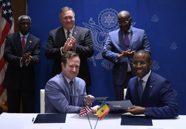 (top row from L) US ambassador to Senegal Tulinabo Mushingi, US Secretary of State Mike Pompeo, and Ambassador of Senegal to the US Mansour Elimane Kane look on as ABD Group CEO John Nevergole (bottom L) shakes hand with Senegal's Minister of Economy, Planning and International Cooperation Amadou Hott after signing a memorandum of understanding (MOU) in Dakar on February 16, 2020. (Andrew Caballero-Reynolds / Pool / AFP via Getty Images)