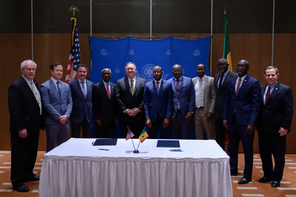 U.S. Secretary of State Mike Pompeo (C,L) and Senegal's Economy, Planning and International Cooperation minister Amadou Hott (C,R) pose with (from L) the President of Weldy-Lamont Patrick Hennelly, ABD Group CEO John Nevergole, General Electric CEO Farid Fezoua, U.S. Ambassador to Senegal Tulinabo Mushingi, Senegalese Ambassador to the United States Mansour Kane, the Director General for Ageroute Ibrahima Ndiaye, an unidentified person, the Director General of Senelec Pape Biteye, and the President of Bechtel Stuart Jones after they signed a memorandum of understanding in Dakar on Feb. 16, 2020. (Andrew Caballero-Reynolds / Pool/ AFP via Getty Images)