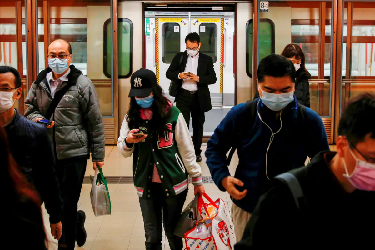 People wear protective masks following the outbreak of a new coronavirus, during their morning commute in a station, in Hong Kong, China on Feb. 10, 2020. (Tyrone Siu/Reuters)