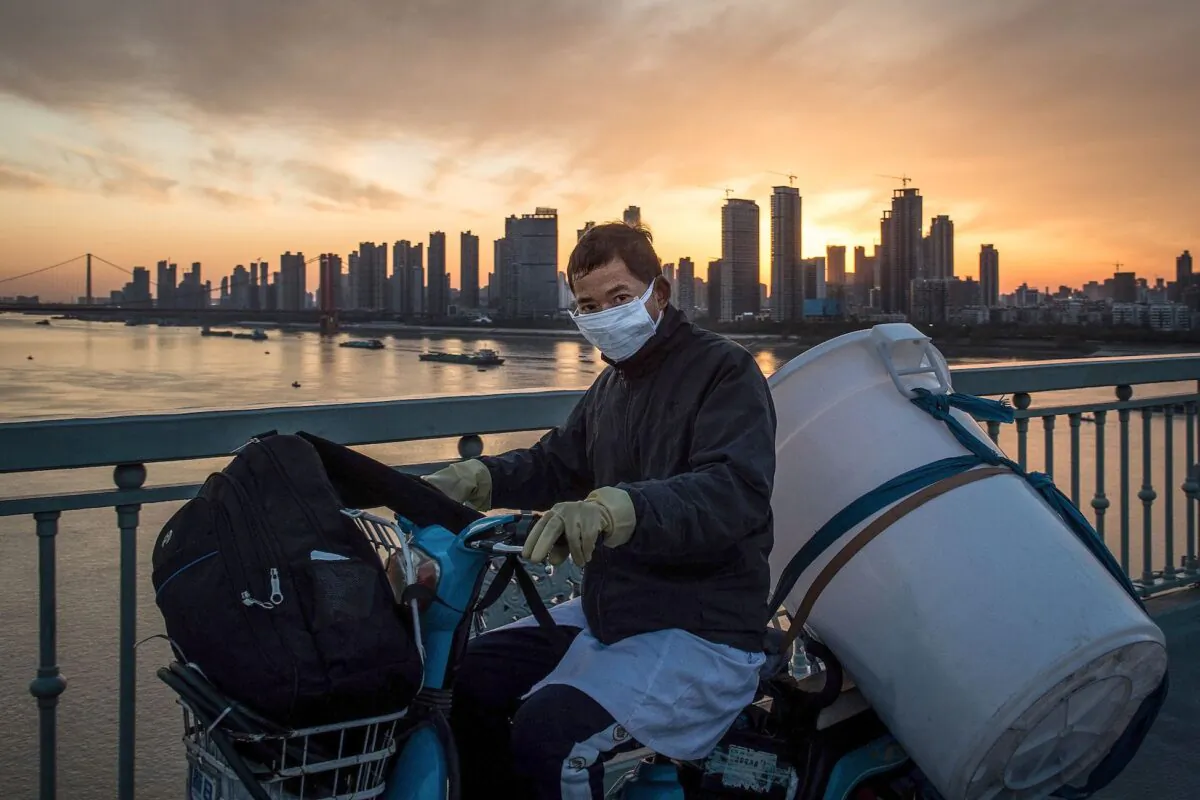 A man wears a protective face mask on a scooter in Wuhan, Hubei province, China, on Feb. 17, 2020. (STR/AFP via Getty Images)