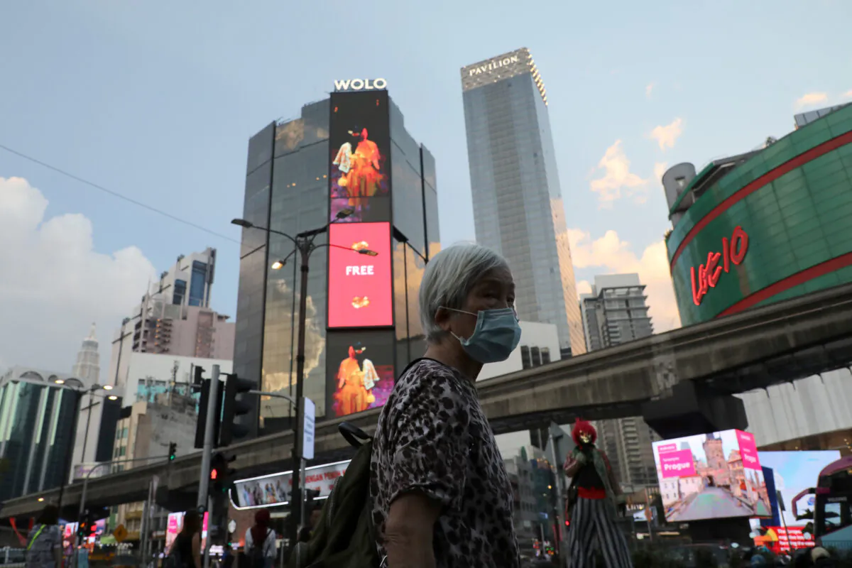A woman wearing protective face mask walks on a street, following the outbreak of the coronavirus in China, in Kuala Lumpur, Malaysia, on Feb. 17, 2020. (Lim Huey Teng/Reuters)