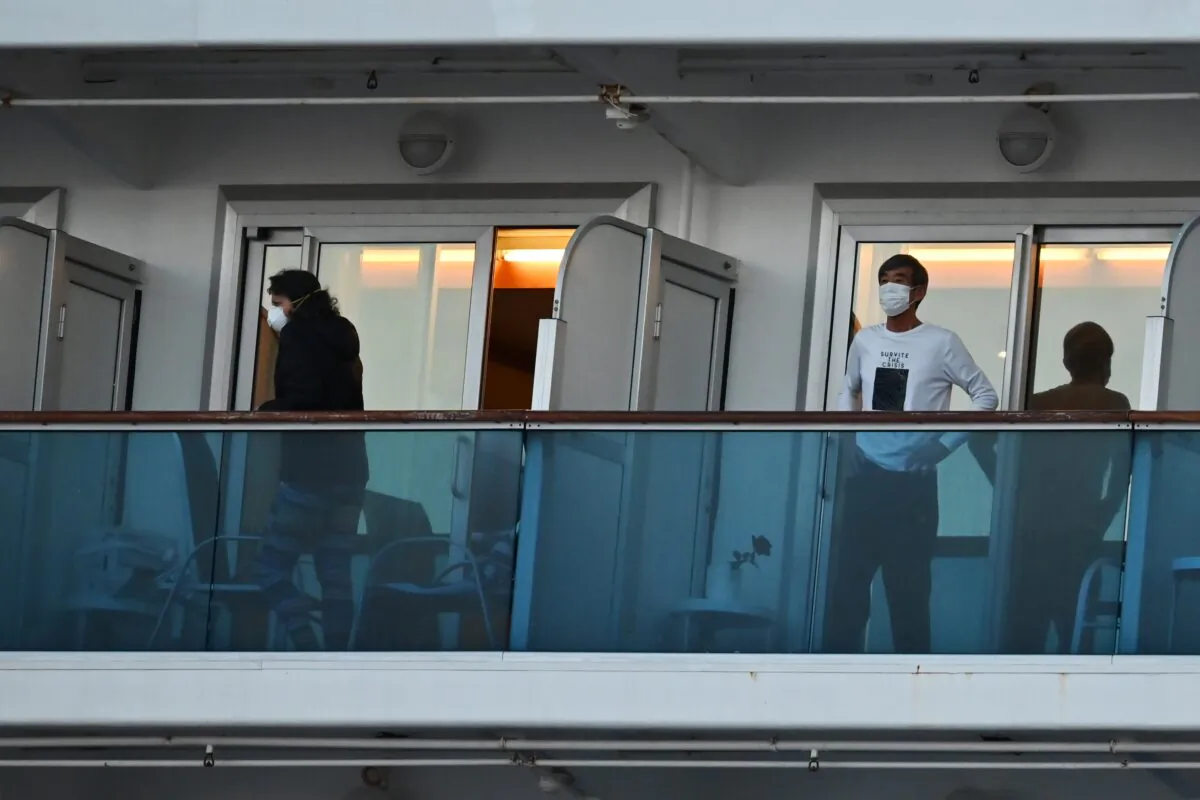 People still in quarantine due to fears of the new COVID-19 coronavirus stand on balconies of the Diamond Princess cruise ship docked at the Daikoku Pier Cruise Terminal in Yokohama, Japan on Feb. 18, 2020. (Charly Triballeau/AFP via Getty Images)
