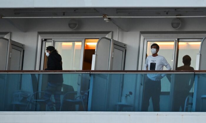People still in quarantine due to fears of the new COVID-19 coronavirus stand on balconies of the Diamond Princess cruise ship docked at the Daikoku Pier Cruise Terminal in Yokohama, Japan on Feb. 18, 2020. (Charly Triballeau/AFP via Getty Images)