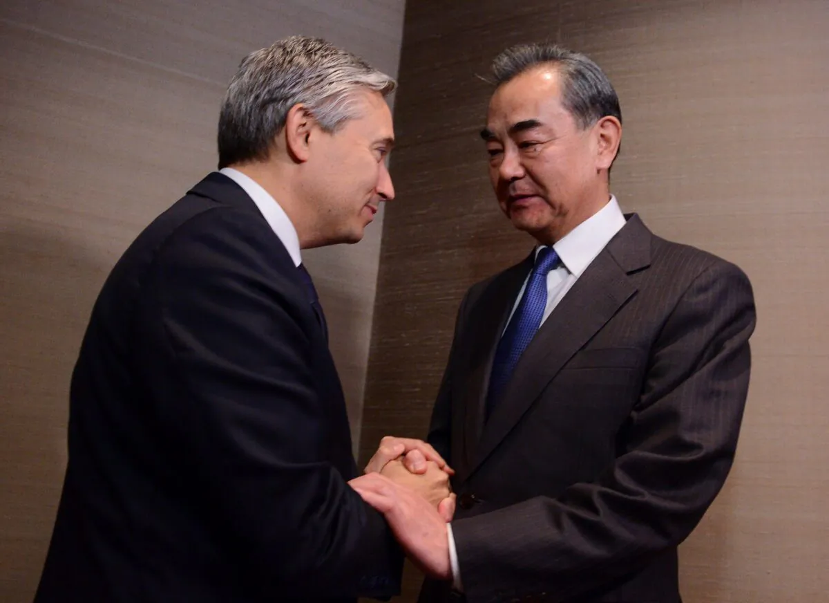 Foreign Affairs Minister Francois-Philippe Champagne shakes hands with Chinese Foreign Minister Wang Yi on the sidelines of the Munich Security Conference in Munich, Germany, on Feb. 14, 2020. (The Canadian Press/Sean Kilpatrick)