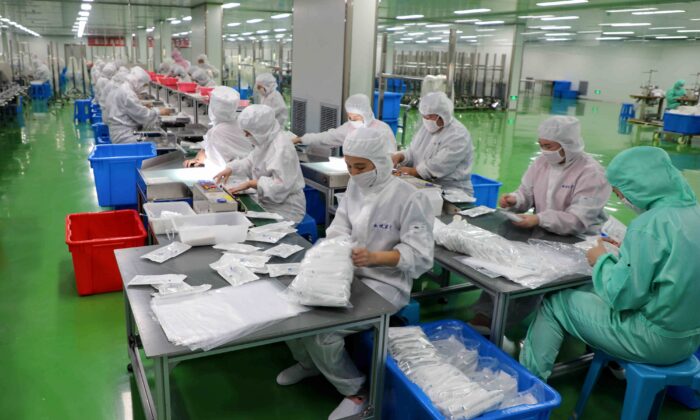 Workers are producing protective suits at a factory in Binzhou city of China's eastern Shandong province on Feb. 13, 2020. (STR/AFP via Getty Images)