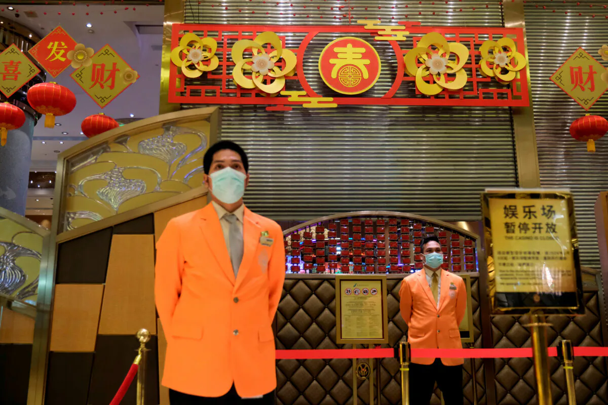 Security guards stand outside the closed Grand Lisboa casino, following the coronavirus outbreak in Macau, China on Feb. 4, 2020. (Tyrone Siu/Reuters)