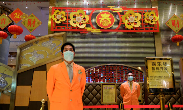 Security guards stand outside the closed Grand Lisboa casino, following the coronavirus outbreak in Macau, China on Feb. 4, 2020. (Tyrone Siu/Reuters)