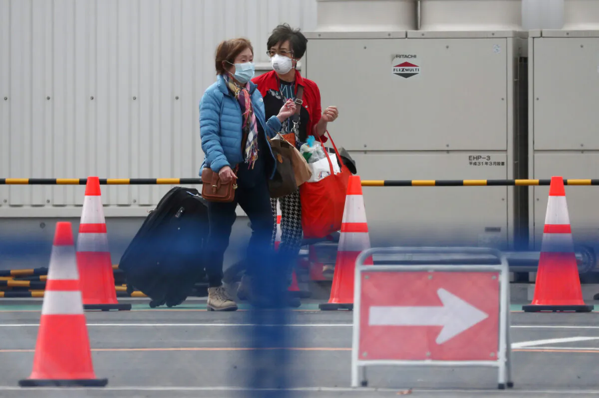 Passengers walk out from the cruise ship Diamond Princess at Daikoku Pier Cruise Terminal in Yokohama, south of Tokyo, Japan on Feb. 19, 2020. (Athit Perawongmetha/Reuters)