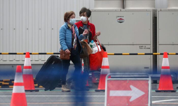 Passengers walk out from the cruise ship Diamond Princess at Daikoku Pier Cruise Terminal in Yokohama, south of Tokyo, Japan on Feb. 19, 2020. (Athit Perawongmetha/Reuters)