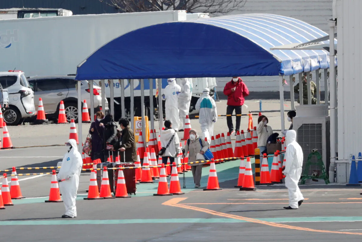 People walk to a taxi queue after leaving the cruise ship Diamond Princess, at the Daikoku Pier Cruise Terminal in Yokohama, south of Tokyo, Japan on Feb. 19, 2020. (Kim Kyung-hoon/Reuters)