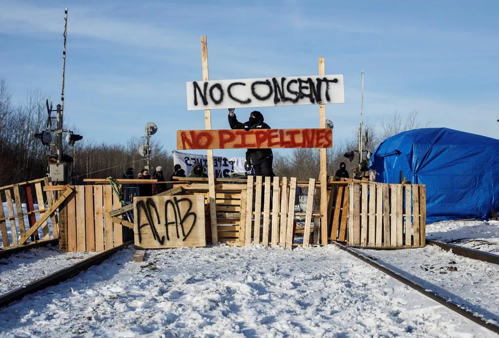 Supporters of the Wet'suwet'en who are against the LNG pipeline, block a CN Rail line just west of Edmonton on Feb. 19, 2020. (Jason Franson/Canadian Press)