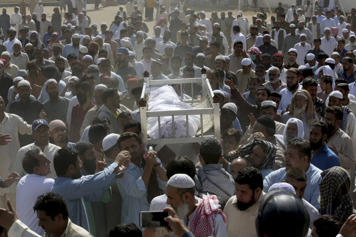 People carry the body of a victim of a toxic gas leak, during his funeral prayer, in Karachi, Pakistan, on Feb. 17, 2020. (Fareed Khan/AP Photo)