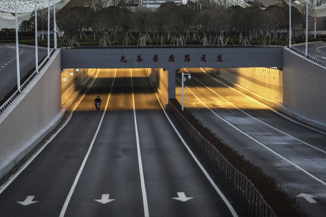 A man is cycling in the empty street at Optical Valley in Wuhan, China on Feb. 16, 2020. (Getty Images)