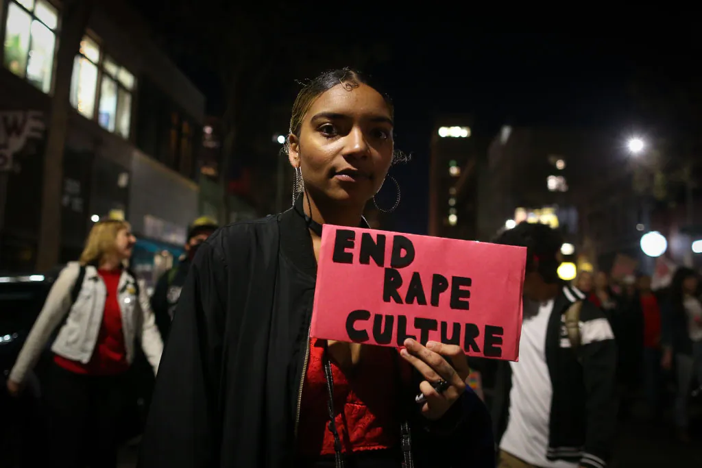 A woman holds a sign reading "End Rape Culture" during a march for International Women's Day  in Oakland, Calif., on March 8, 2017. (Elijah Nouvelage/Getty Images)
