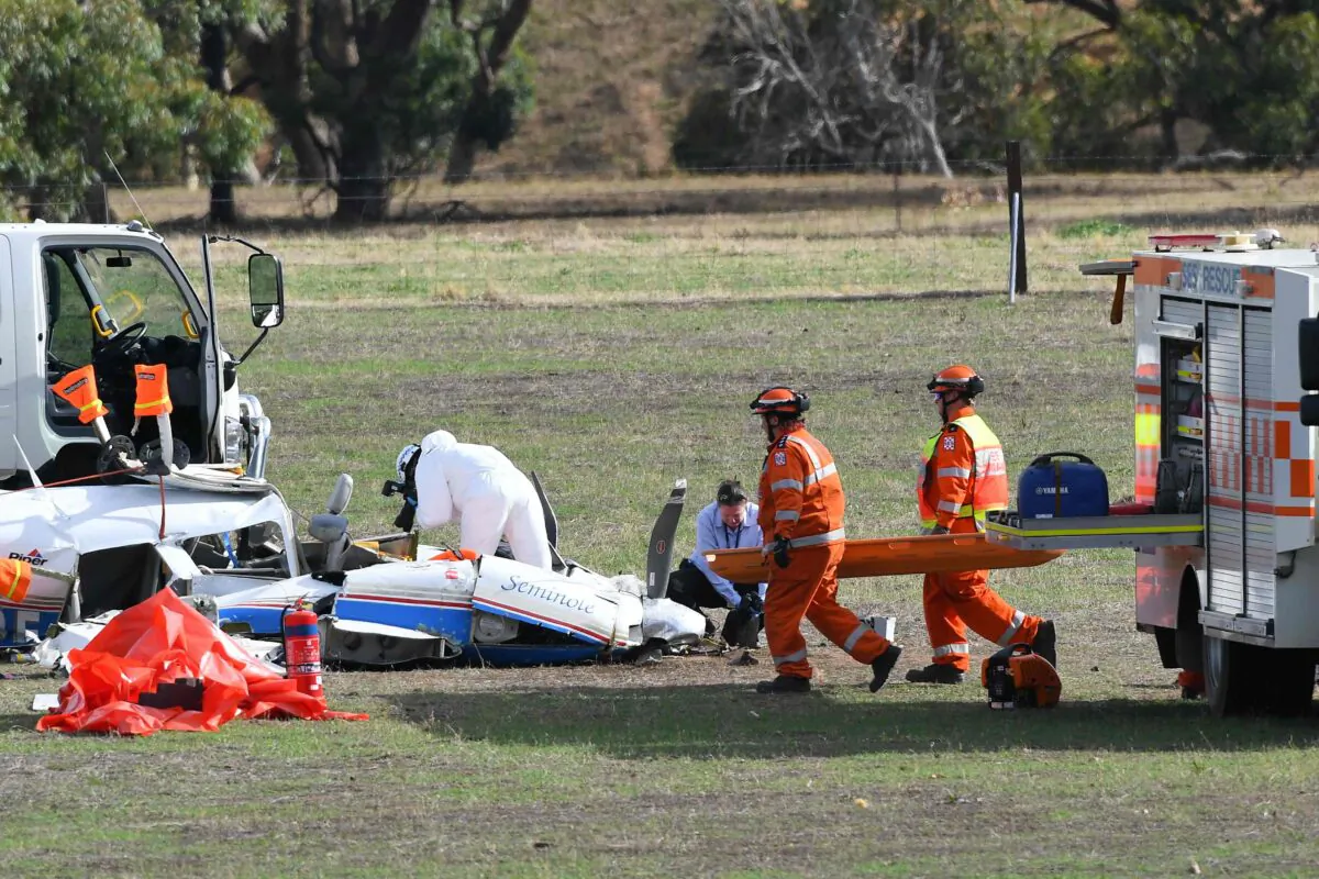 Emergency service personnel attend to the wreckage of a light aircraft on a property at Avenel in Victoria, Australia, on Feb. 19, 2020. (AAP Image/James Ross)