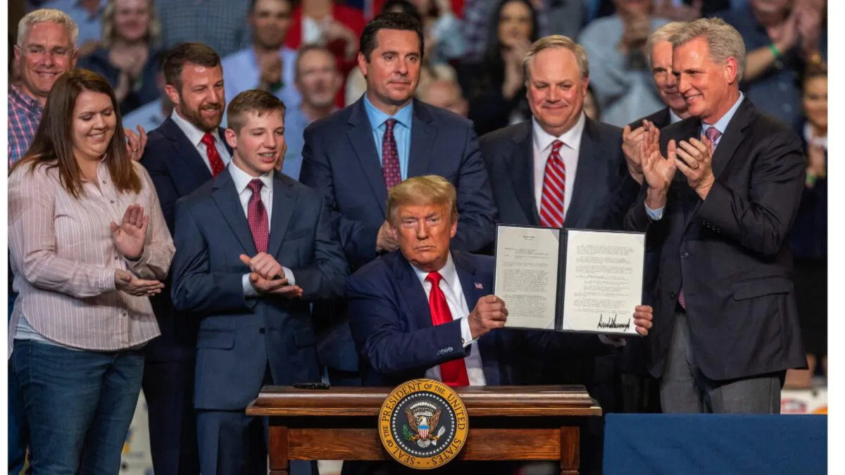 President Donald Trump ceremonially signs legislation at a rally with local farmers in Bakersfield, California, on Feb. 19, 2020. (David McNew/Getty Images)