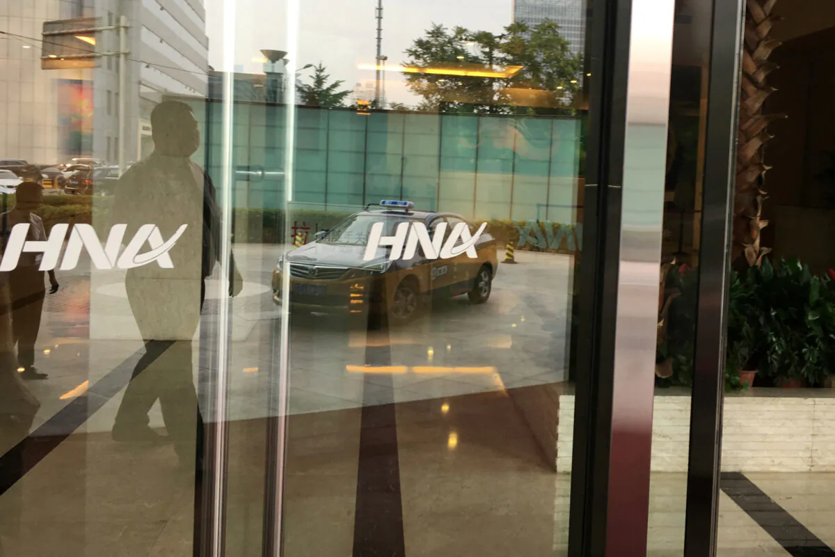 The HNA Group logo is seen on the gate of HNA Plaza building in Beijing, China on July 4, 2018. (Elias Glenn/Reuters)