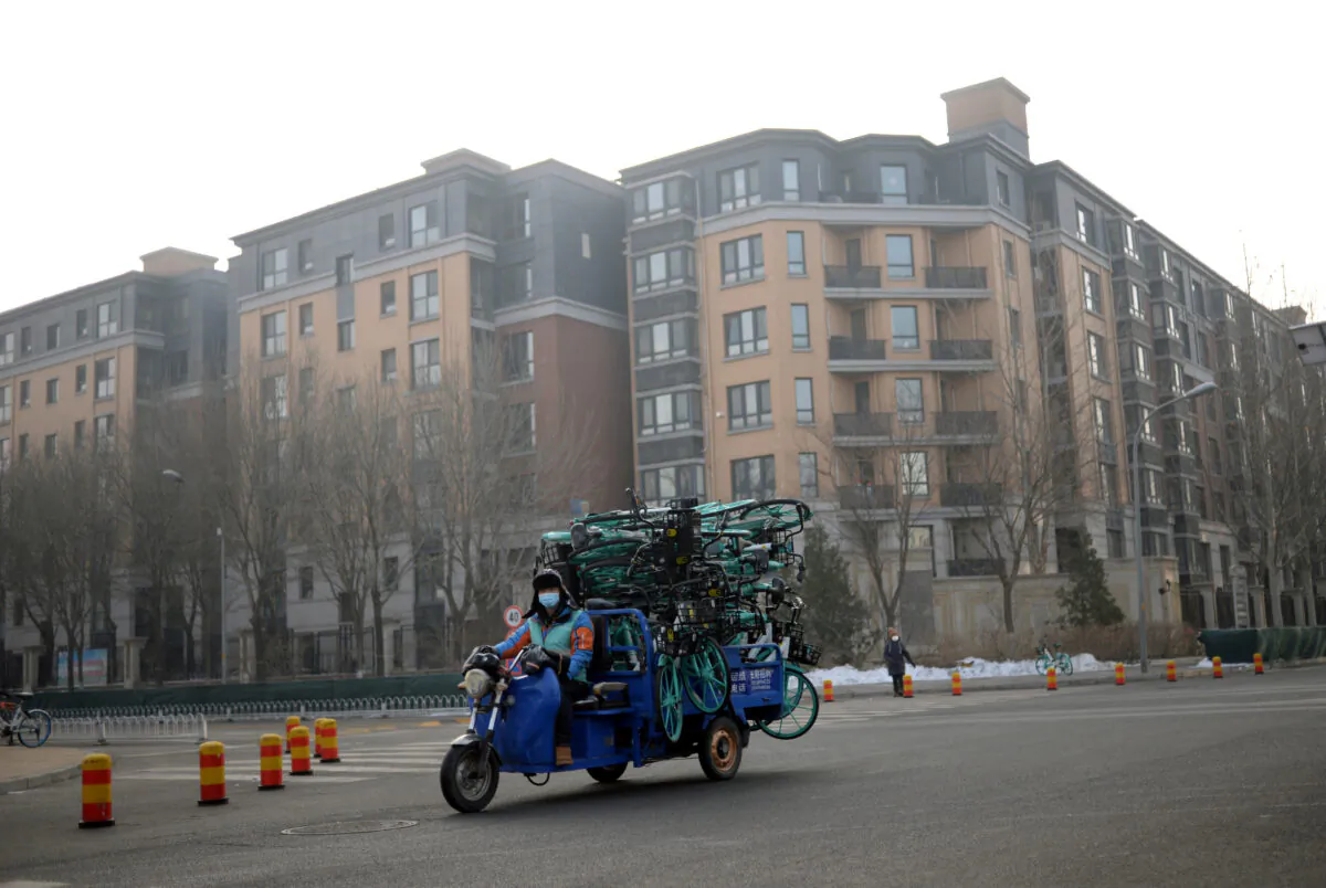 A worker drives a vehicle carrying bicycles from Didi Chuxing's bike sharing service in the morning after the extended Lunar New Year holiday caused by the novel coronavirus outbreak, near Zhongguancun Software Park, in Beijing, China on Feb. 10, 2020. (Tingshu Wang/Reuters)