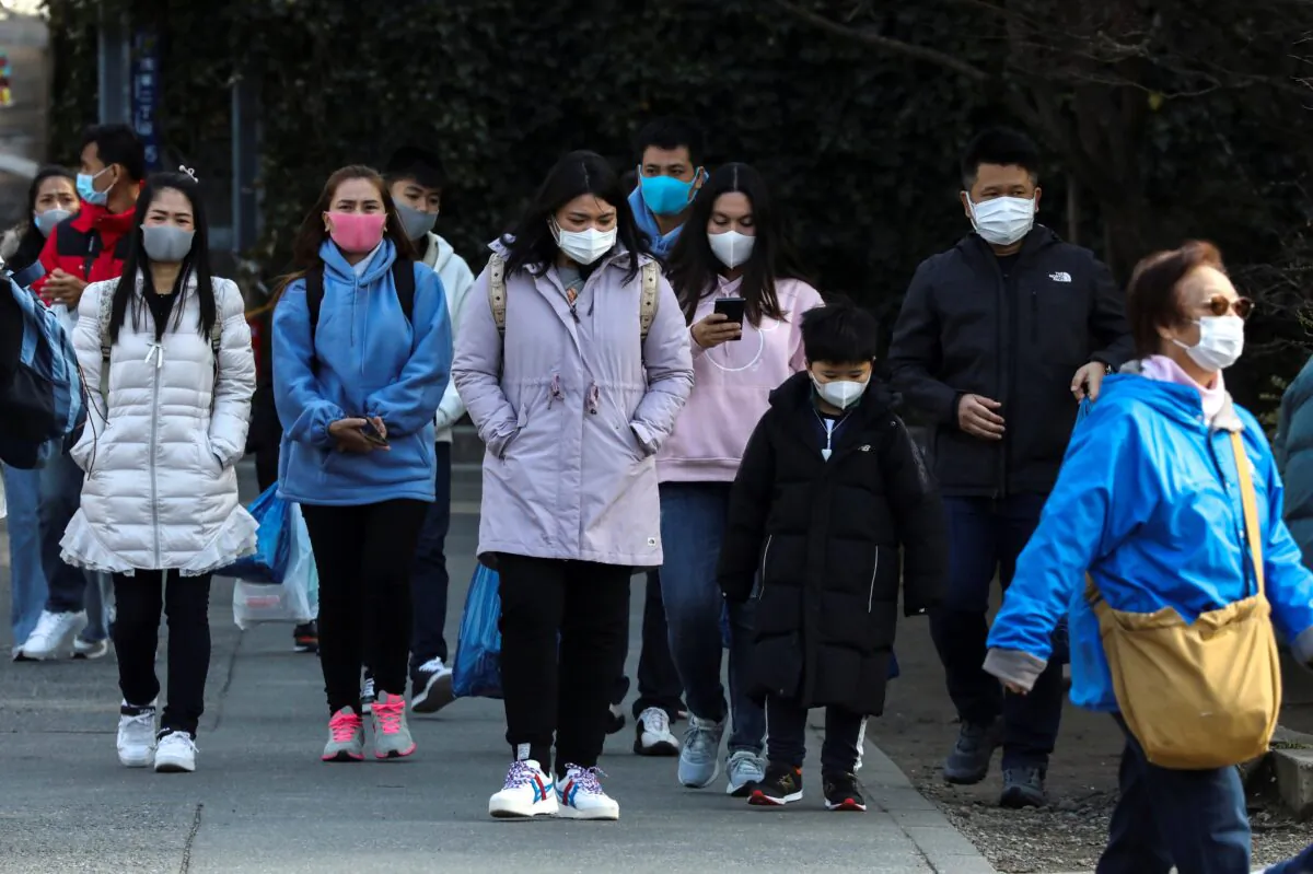 Tourists wearing protective masks visit Sensoji Temple in Asakusa district in Tokyo on Feb. 18, 2020. (Athit Perawongmetha/Reuters)