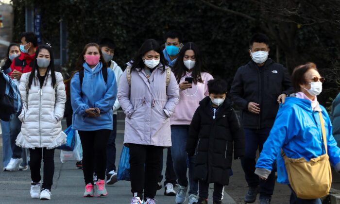 Tourists wearing protective masks visit Sensoji Temple in Asakusa district in Tokyo on Feb. 18, 2020. (Athit Perawongmetha/Reuters)