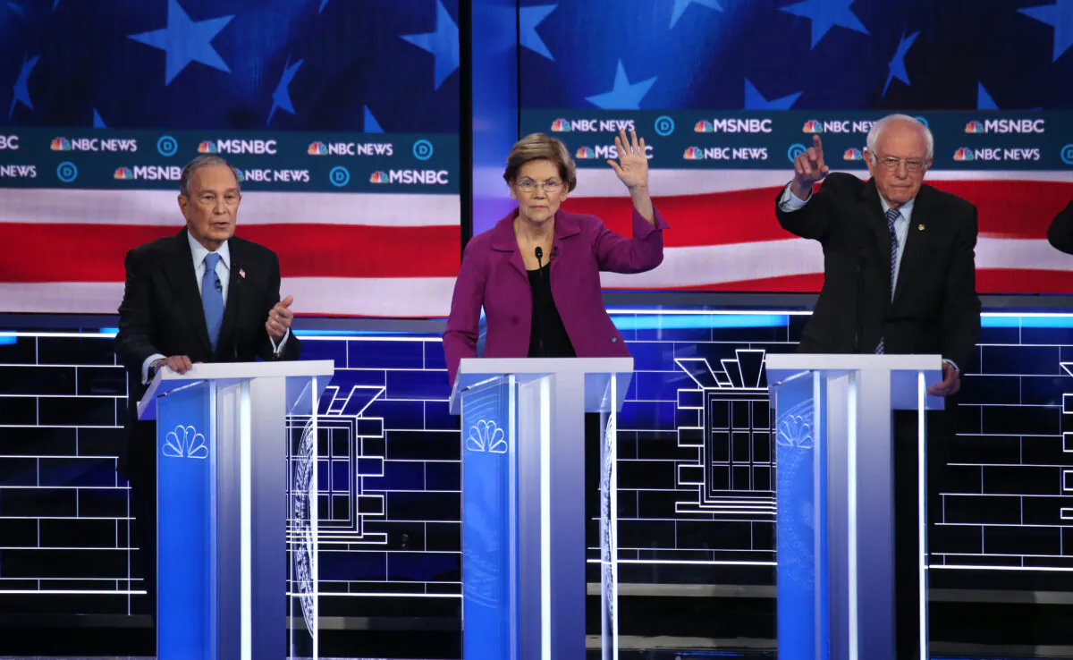 Democratic presidential candidates (L–R) former New York City Mayor Mike Bloomberg speaks as Sen. Elizabeth Warren (D-Mass.), and Sen. Bernie Sanders (I-Vt.) react during the Democratic presidential primary debate at Paris Las Vegas on Feb. 19, 2020. (Mario Tama/Getty Images)