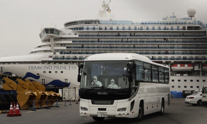 A bus leaves a port where the quarantined Diamond Princess cruise ship is docked on Feb. 15, 2020, in Yokohama, near Tokyo, Japan. (AP Photo/Jae C. Hong)
