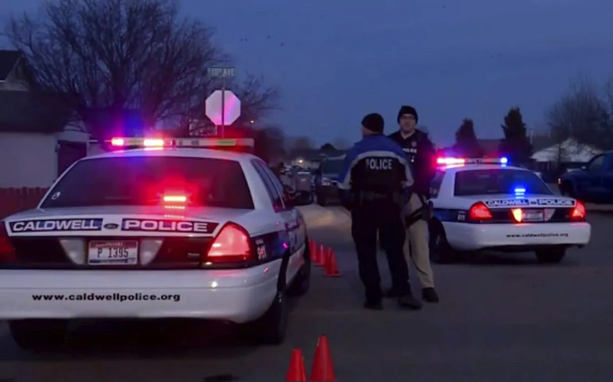 Police cars and officers are seen near the site of a shooting in Caldwell, Idaho, on Feb. 20, 2020. (KBOI/CBS 2 via AP)